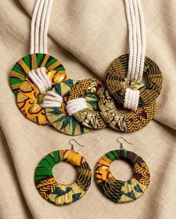 No.1: Afro-Cuban Ankara necklace and earring set with rope details. Braided rope meets vibrant Ankara wax-print fabric. This set combines texture and color to create an expressive piece of jewelry.