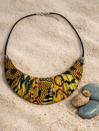 No. 11: Afro-Cuban Ankara crescent necklace in gold, blue, and dark red. A striking statement piece with clean lines and bold colors that instantly adds flair and elegance to any outfit.