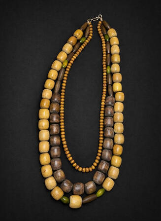 No. 8: A three-strand wooden bead necklace. Multiple strands and varying wood tones create depth and a harmonious overall look.