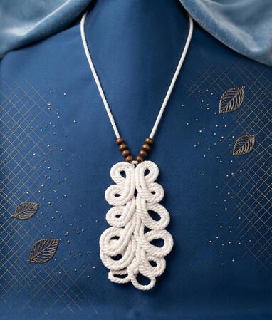 No. 10: Macramé leaf necklace with wooden beads. The delicate, organic-shaped weave gives this piece a light, natural look.